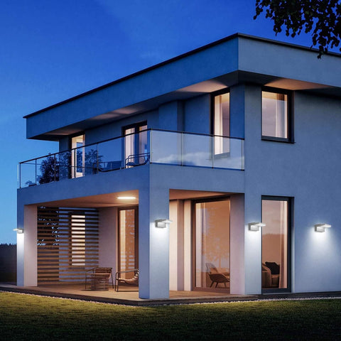 Modern house exterior with illuminated windows at night