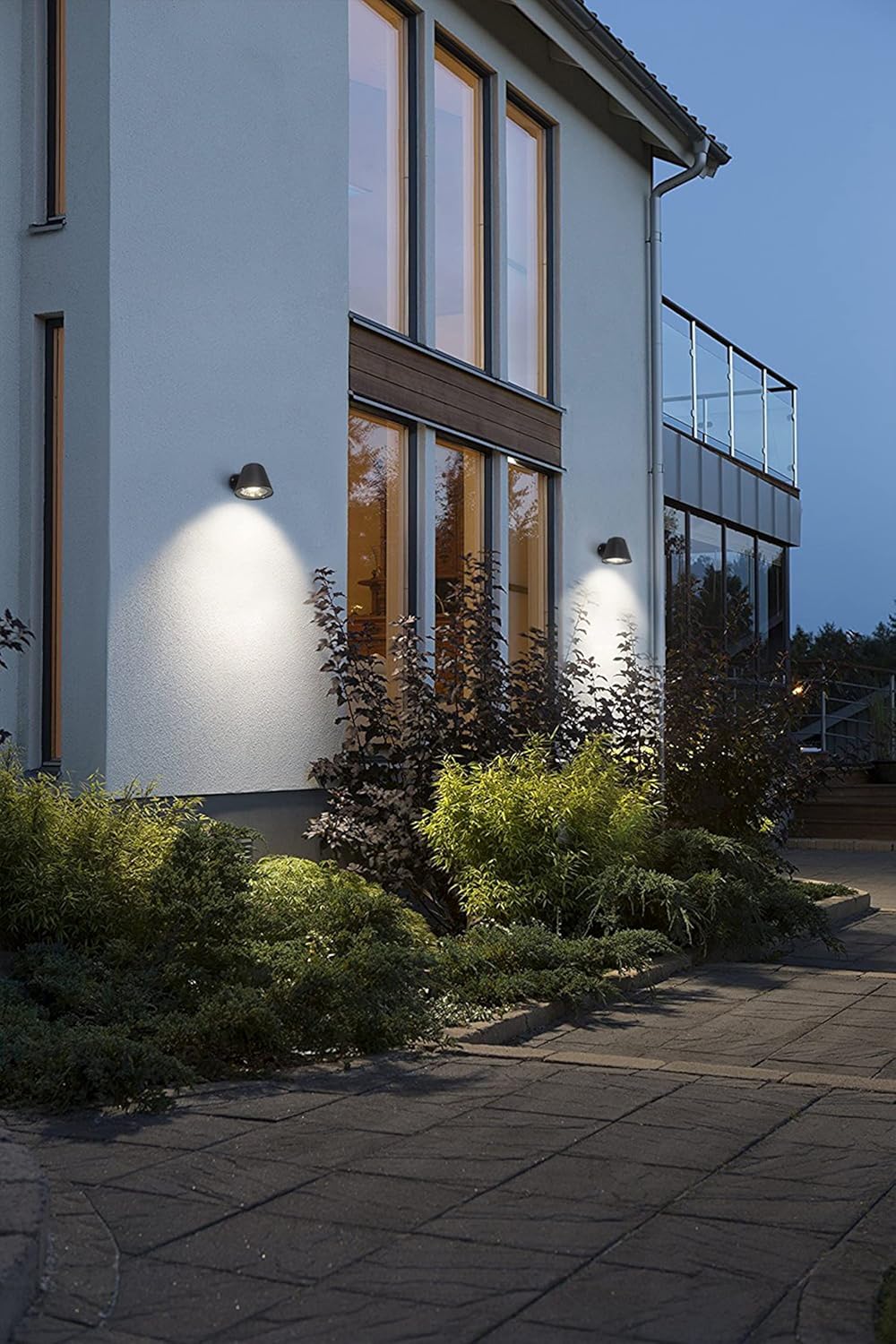 Modern house exterior with wall lights on a clear night