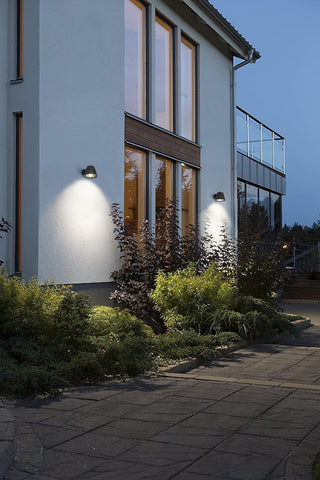 Modern house exterior with wall lights on a clear night