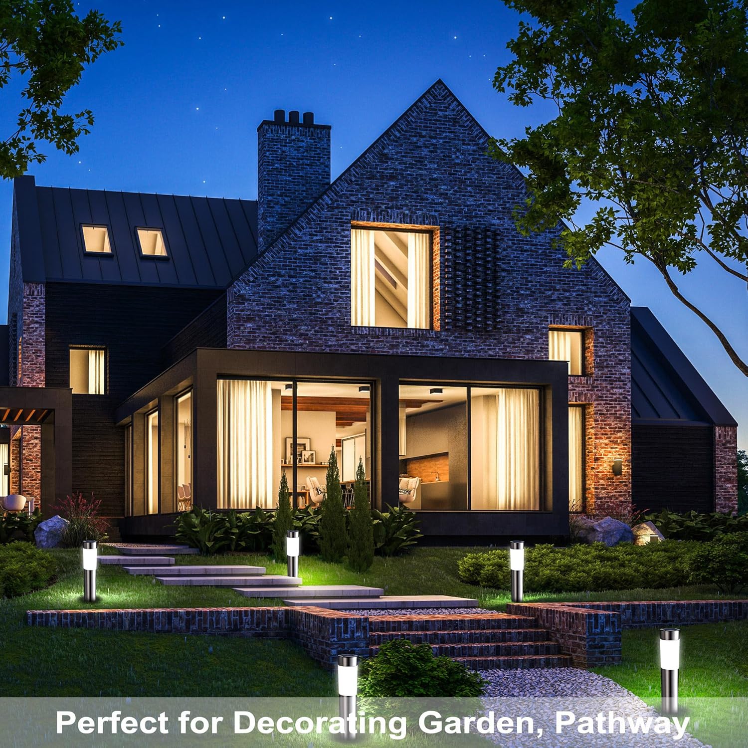 Modern house with illuminated windows at night, surrounded by garden and pathway.