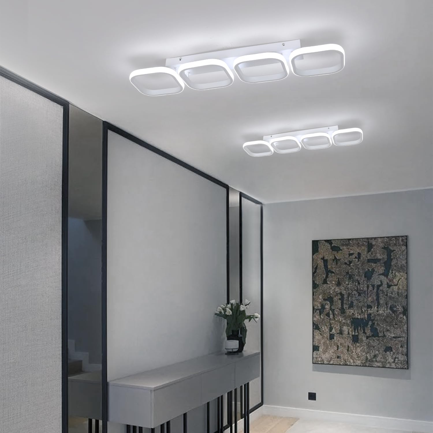 Modern interior design with ceiling lights, mirror, and abstract painting.
