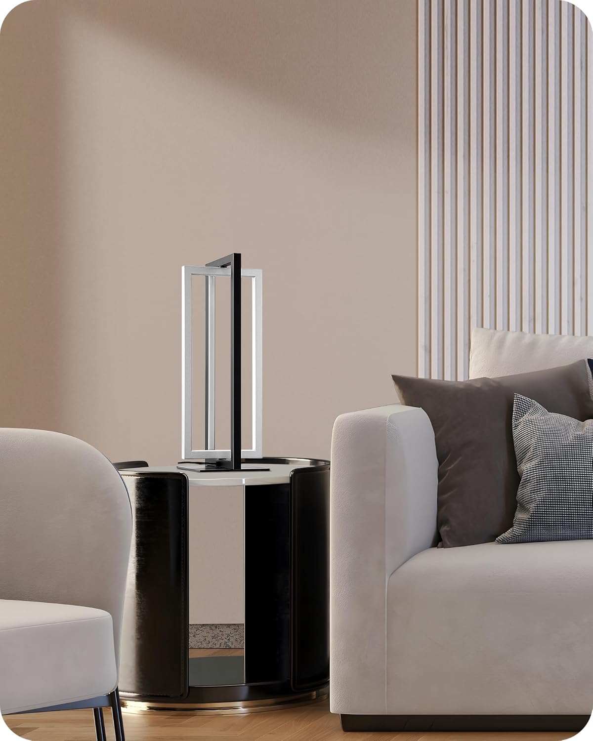 Modern interior with a black cylindrical table and gray sofa against a beige wall.