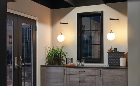 Modern interior with a mirror, plant, and decorative items on a countertop.
