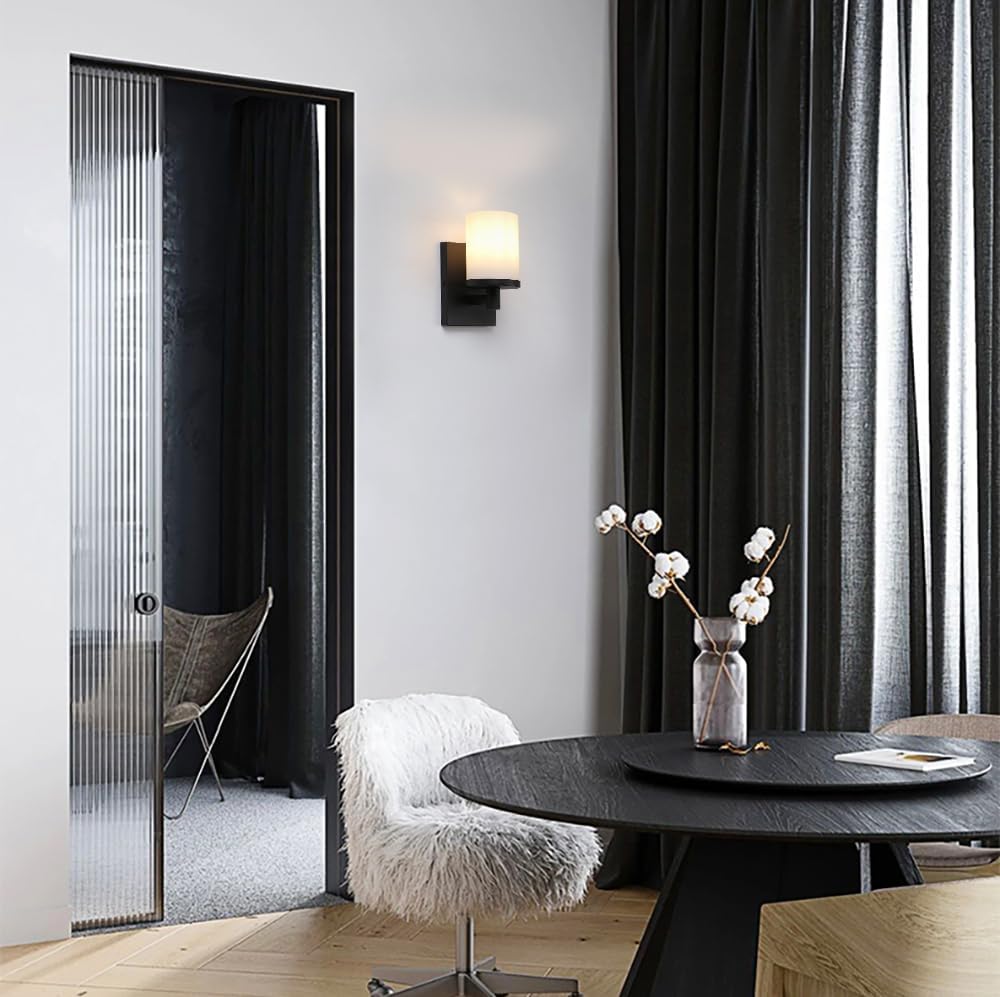 Modern interior with a round black dining table, chairs, and decorative elements.