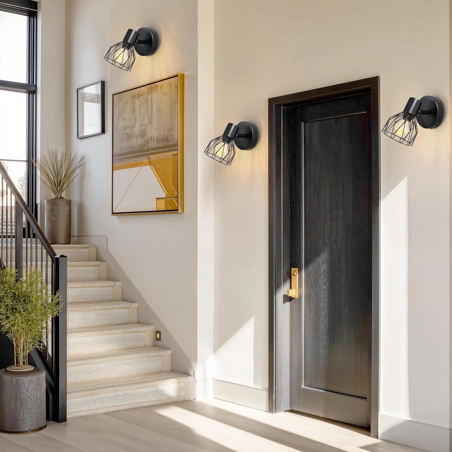 Modern interior with a staircase, wall lights, and a door.