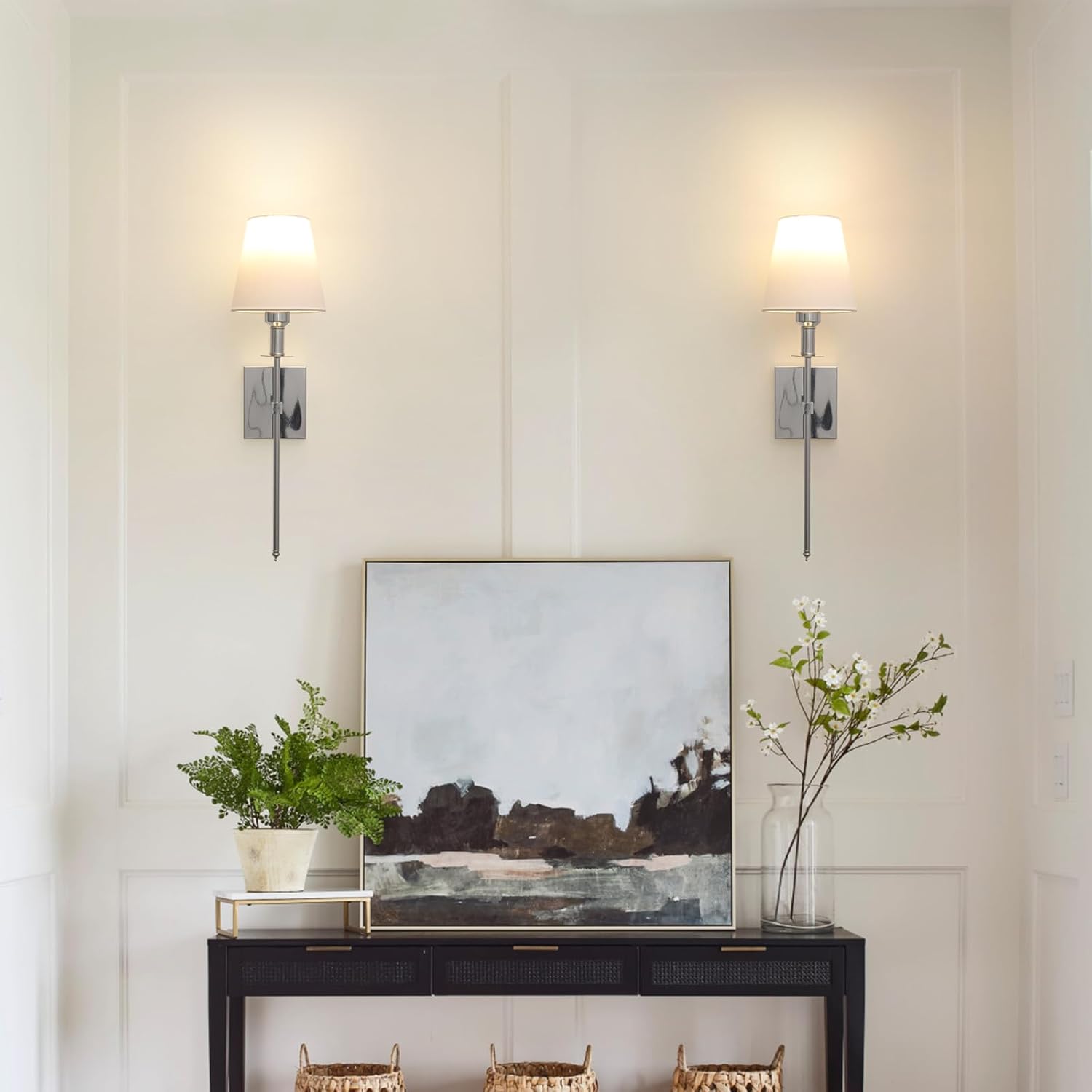 Modern interior with wall sconces, a console table, and decorative items.