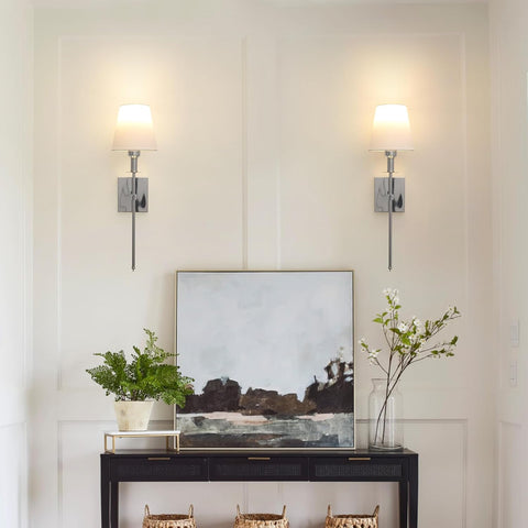 Modern interior with wall sconces, a console table, and decorative items.