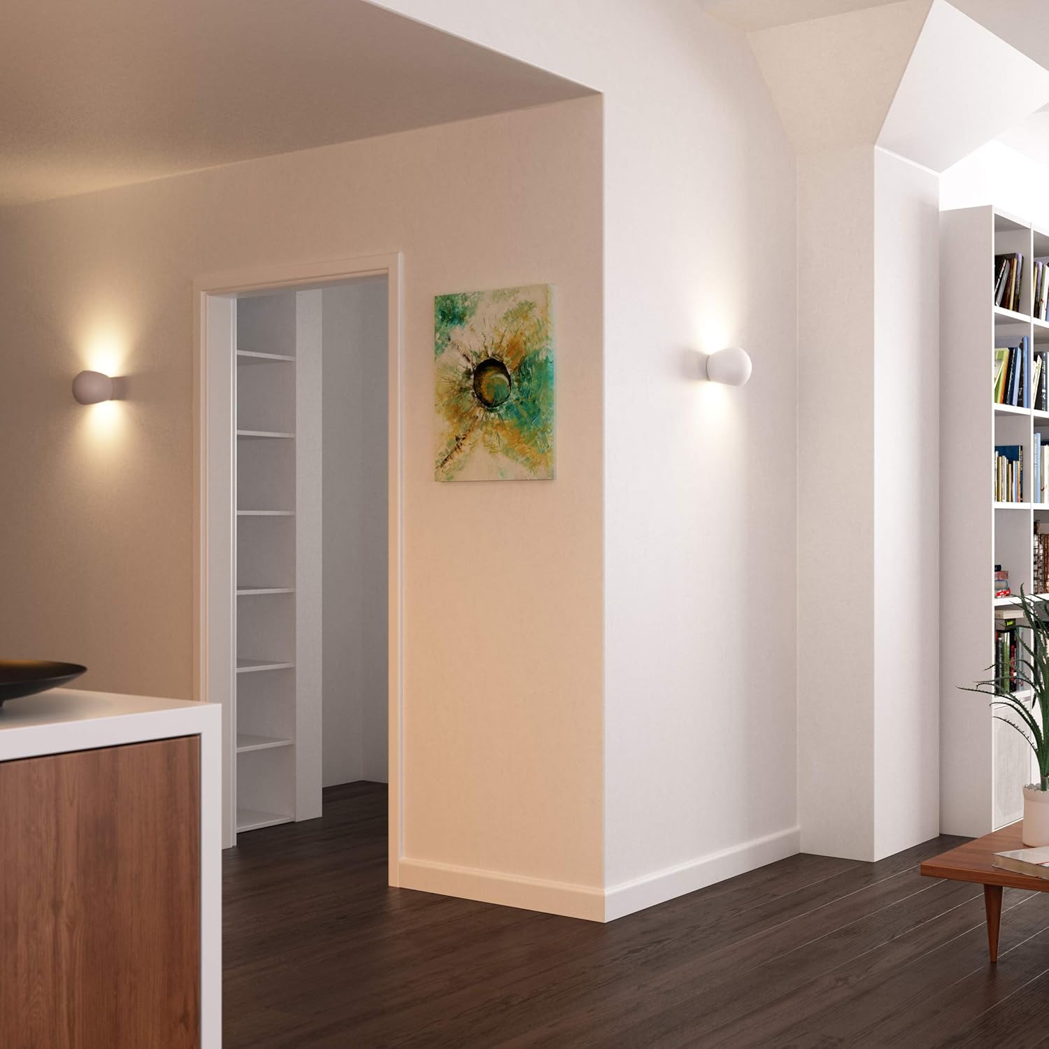 Modern interior with wall sconces, a painting, and bookshelves.