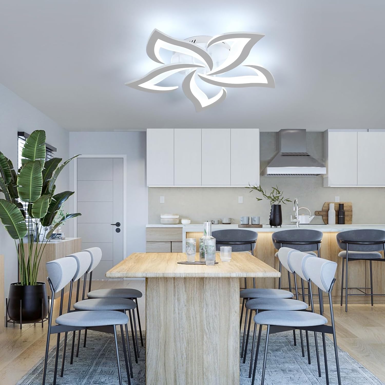 Modern kitchen with a ceiling light fixture, dining table, and chairs.
