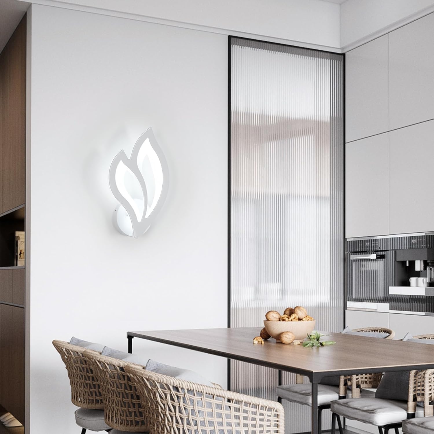 Modern kitchen with a dining table and chairs, featuring a wall-mounted light fixture.