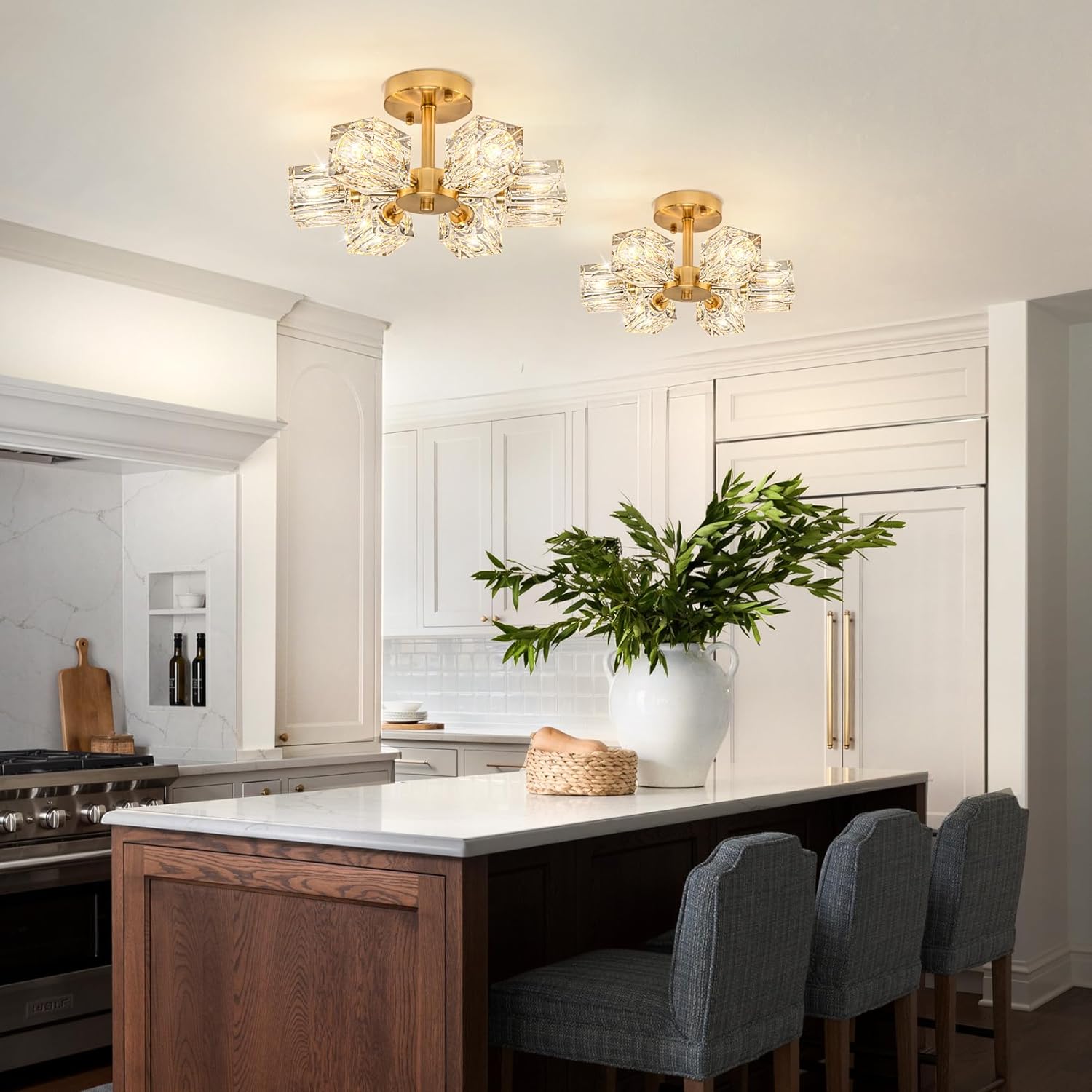 Modern kitchen with gold ceiling lights, white island, and gray chairs.