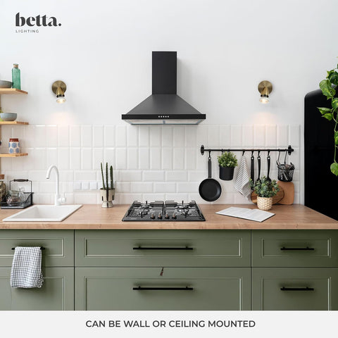 Modern kitchen with green cabinets, black stove, and black range hood, featuring the brand 'betta'.