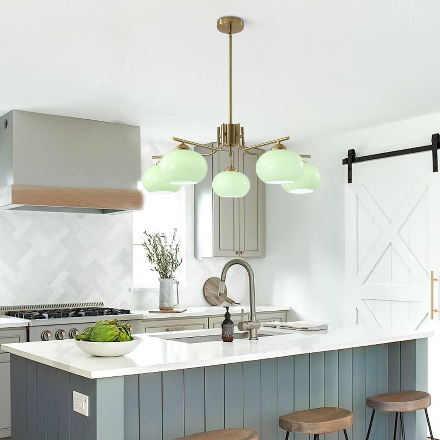 Modern kitchen with green pendant lights, white countertops, and wooden stools.