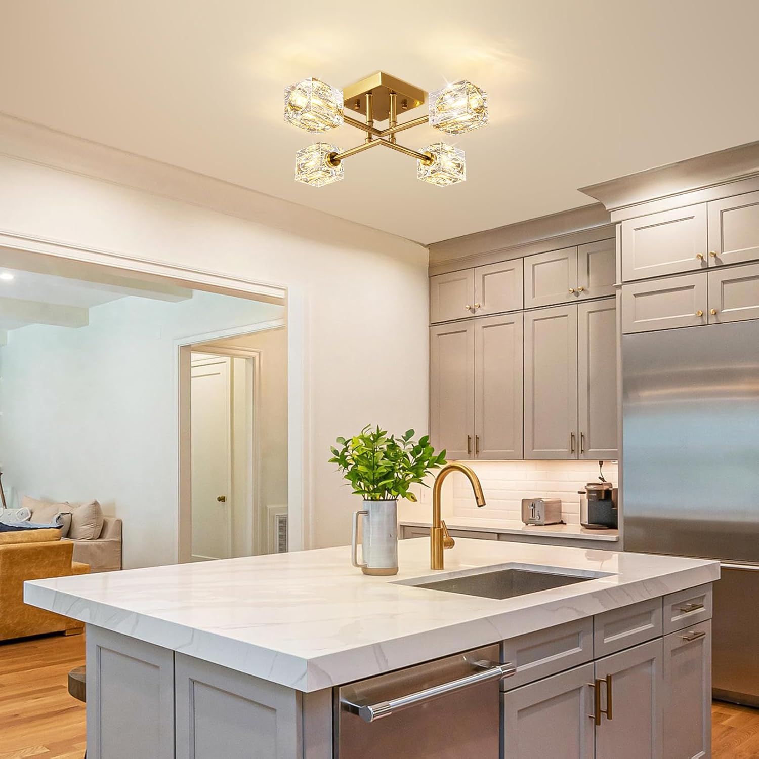 Modern kitchen with marble island, stainless steel appliances, and decorative light fixture.