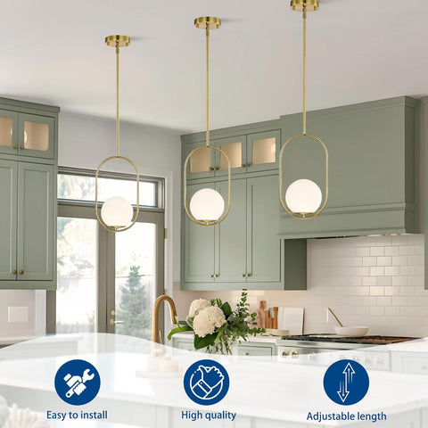 Modern kitchen with pendant lights, green cabinets, and a white countertop.