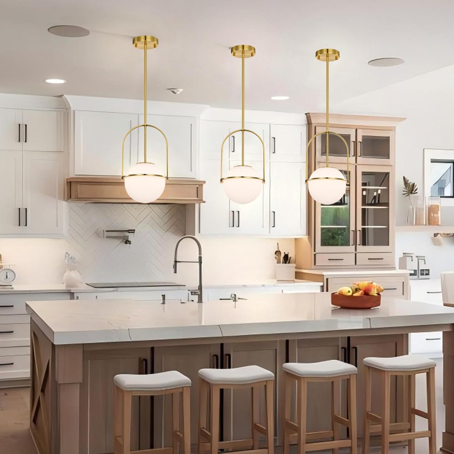 Modern kitchen with pendant lights, island, and bar stools.