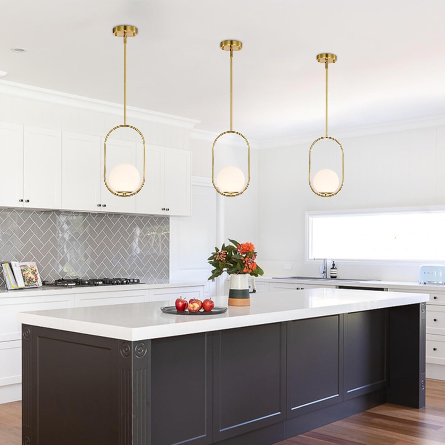Modern kitchen with pendant lights, white countertops, and dark cabinets.