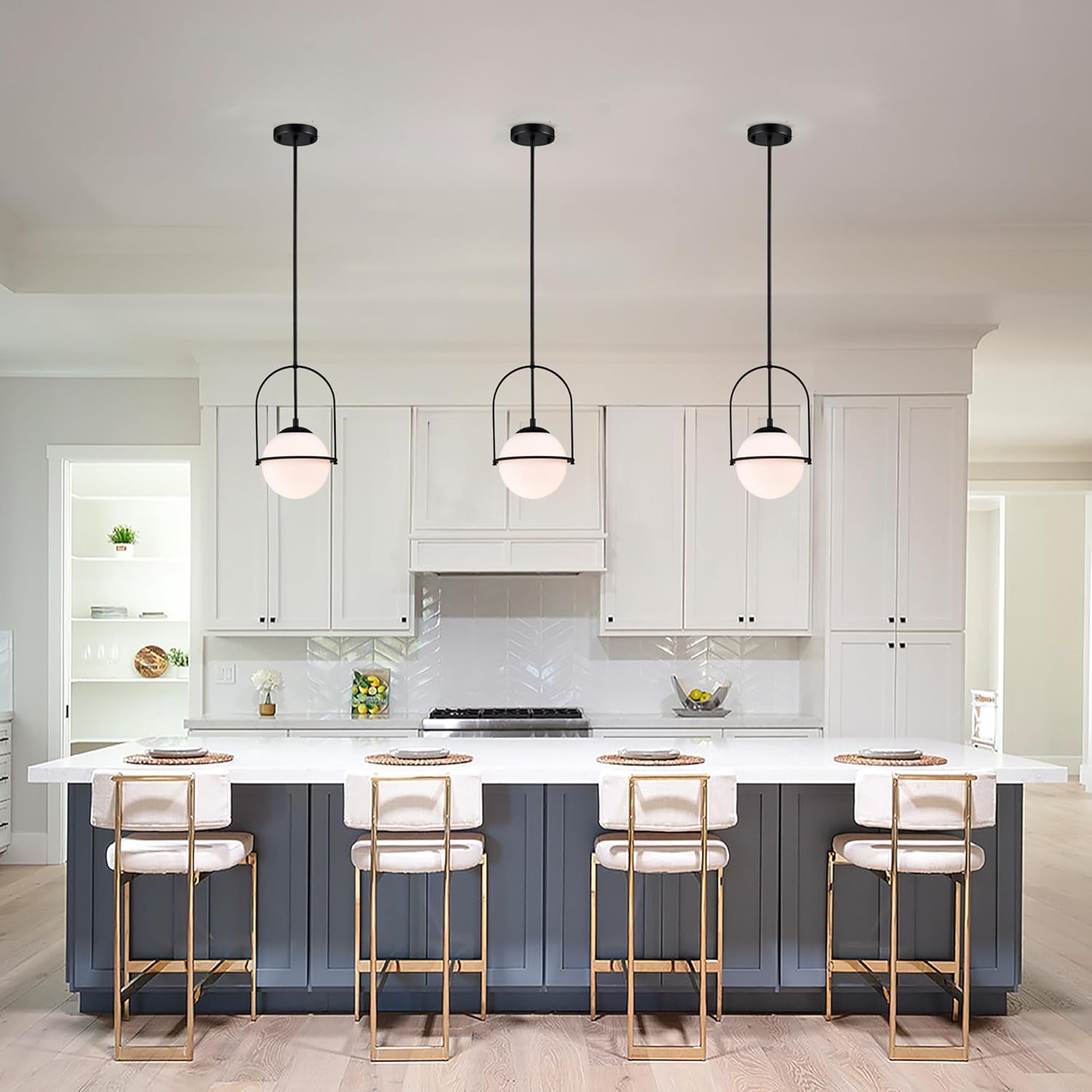 Modern kitchen with white cabinets, a island, and pendant lights.