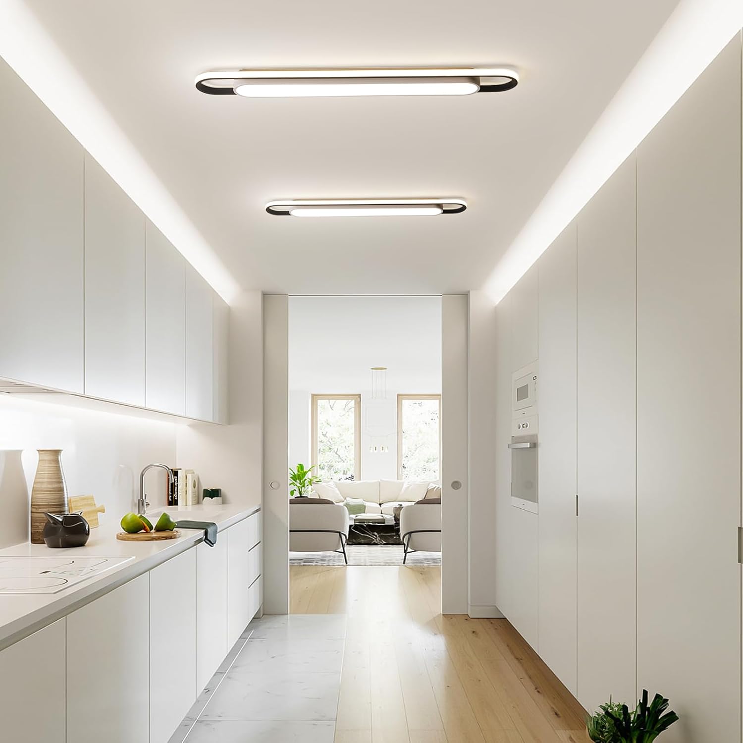 Modern kitchen with white cabinets and a view into a living room.