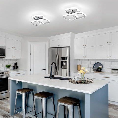 Modern kitchen with white cabinets, stainless steel appliances, and a central island.
