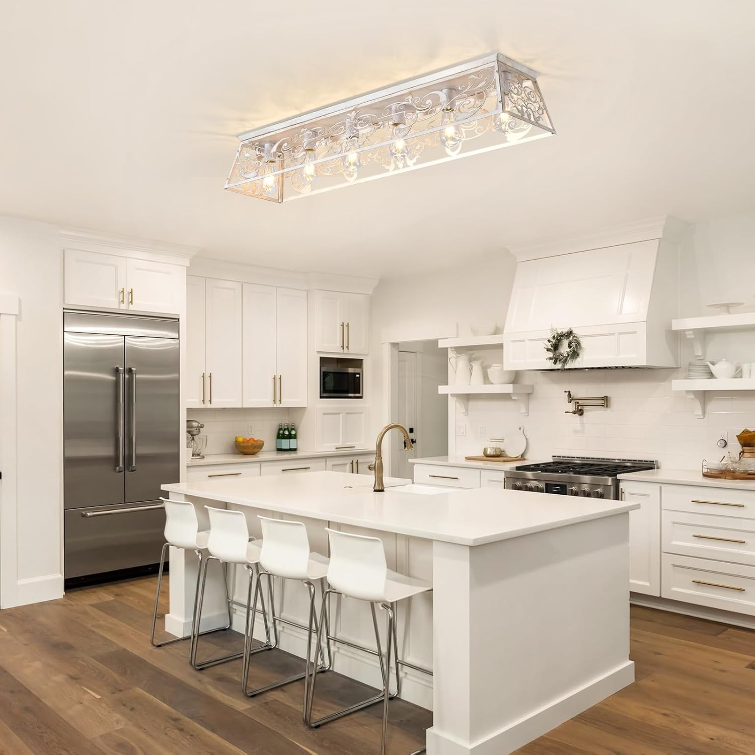 Modern kitchen with white cabinets, stainless steel appliances, and a island.