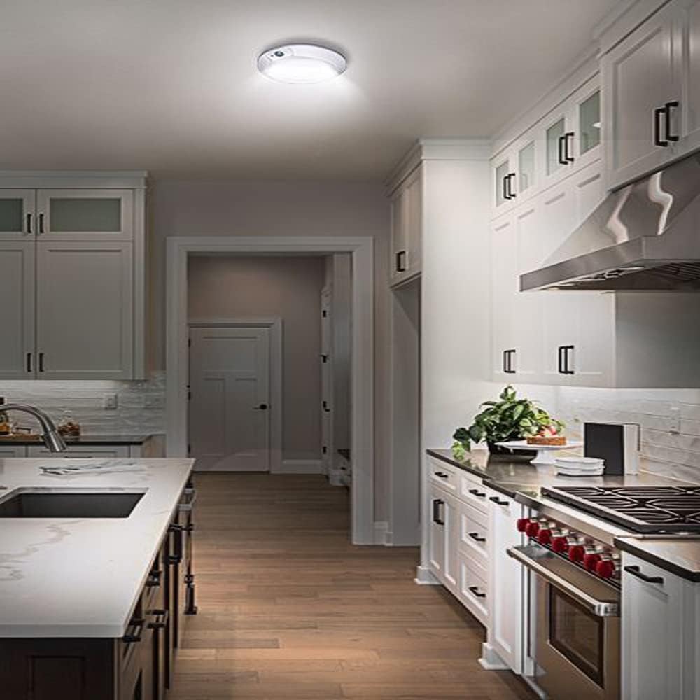 Modern kitchen with white cabinets, stainless steel appliances, and a neutral color palette.