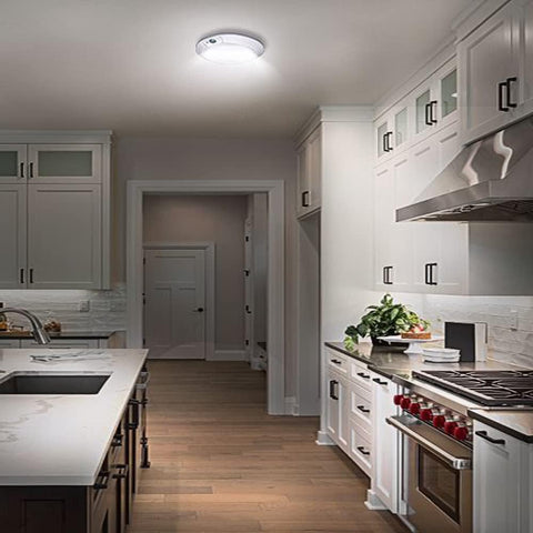 Modern kitchen with white cabinets, stainless steel appliances, and a neutral color palette.