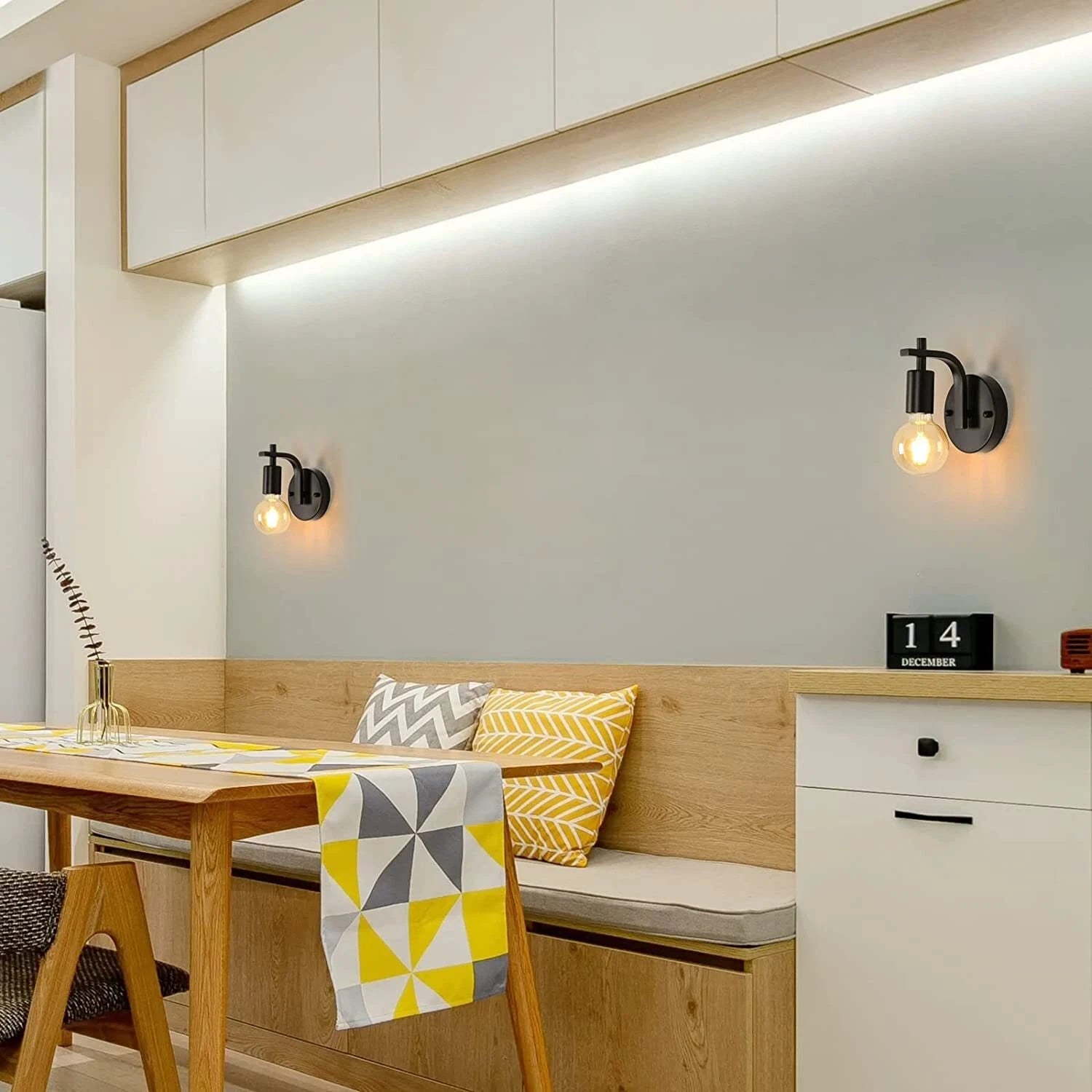 Modern kitchen with wooden bench, table, and decorative elements.
