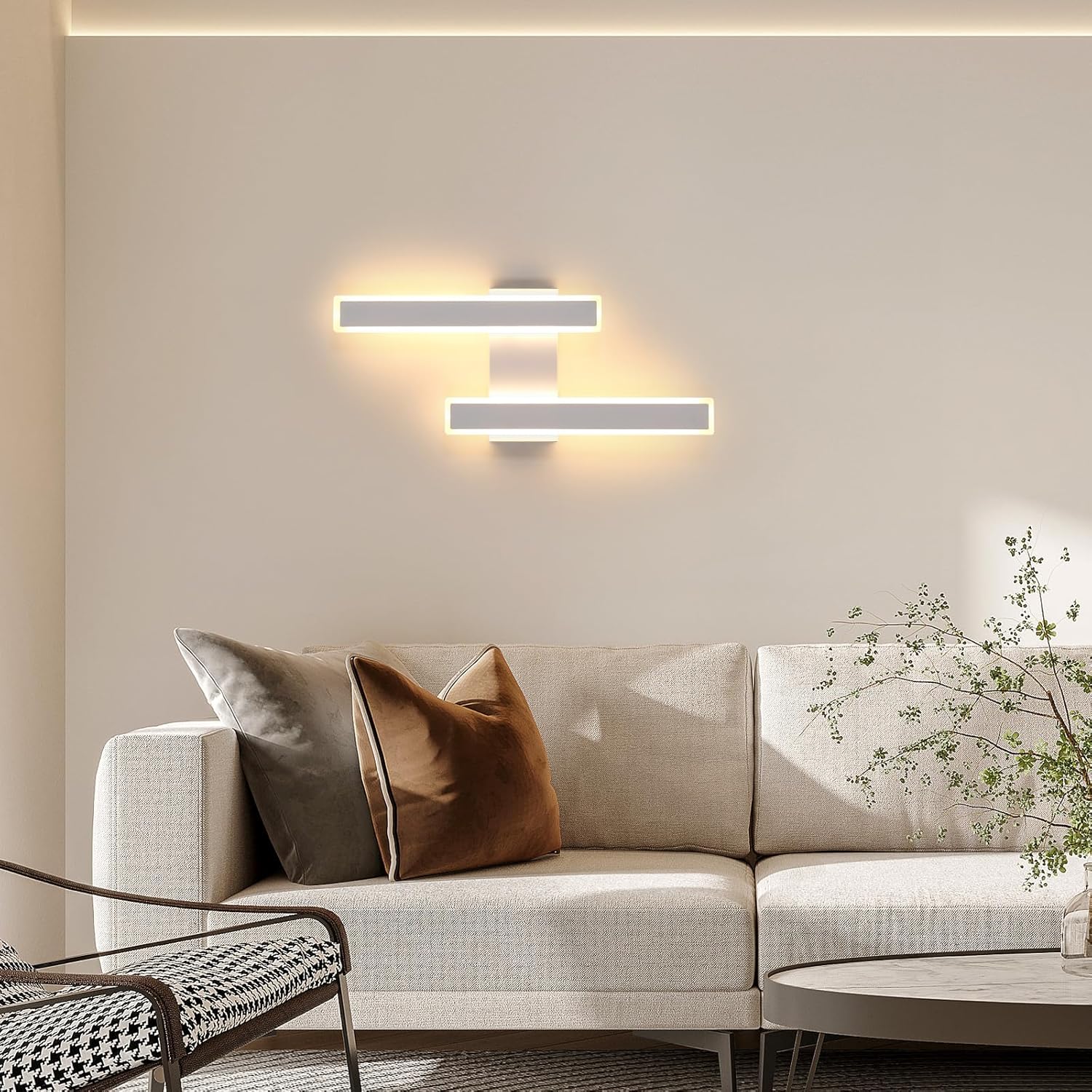 Modern living room with a beige sofa, decorative pillows, and wall lights.