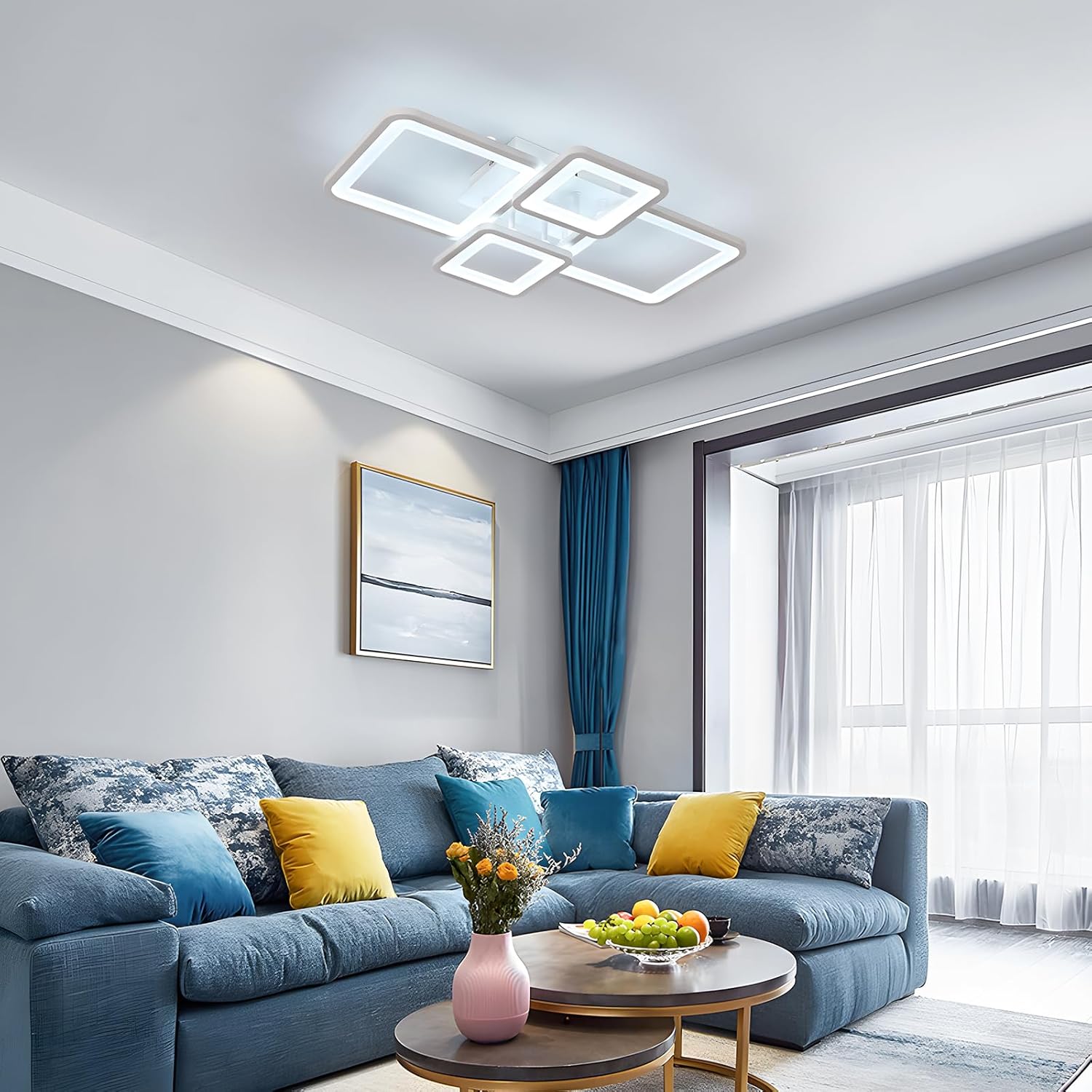 Modern living room with a blue sofa, decorative pillows, and a ceiling light fixture.
