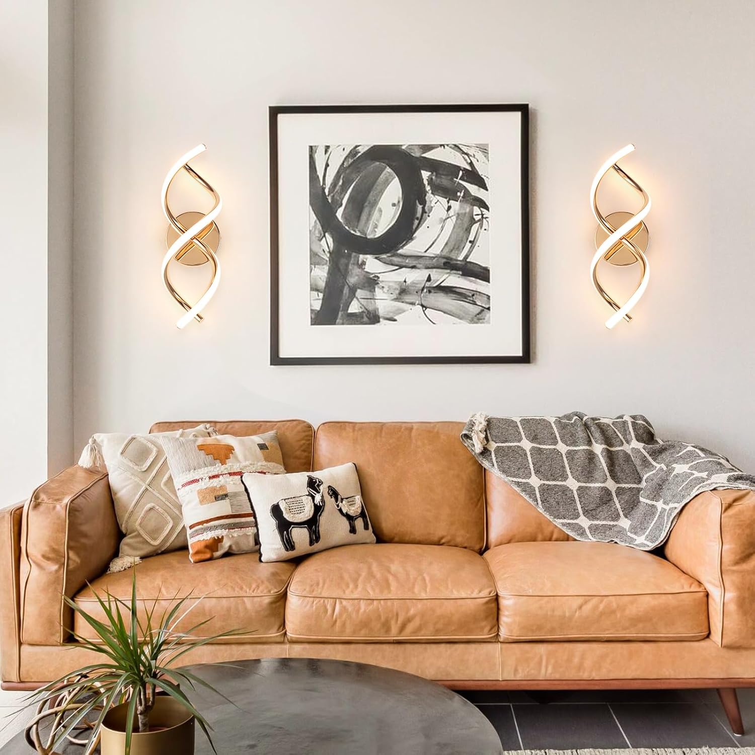 Modern living room with a brown leather sofa, decorative pillows, and wall art.