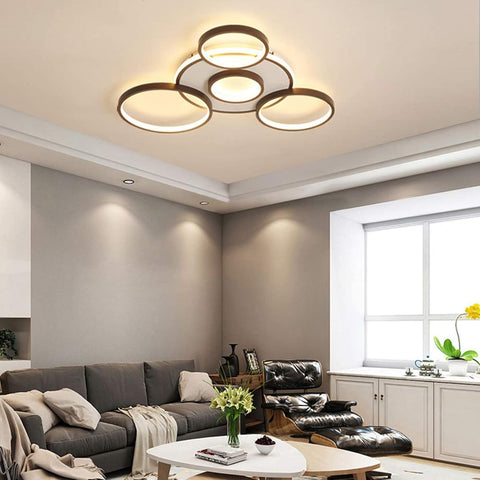 Modern living room with a ceiling light fixture, gray sofa, and black leather chair.