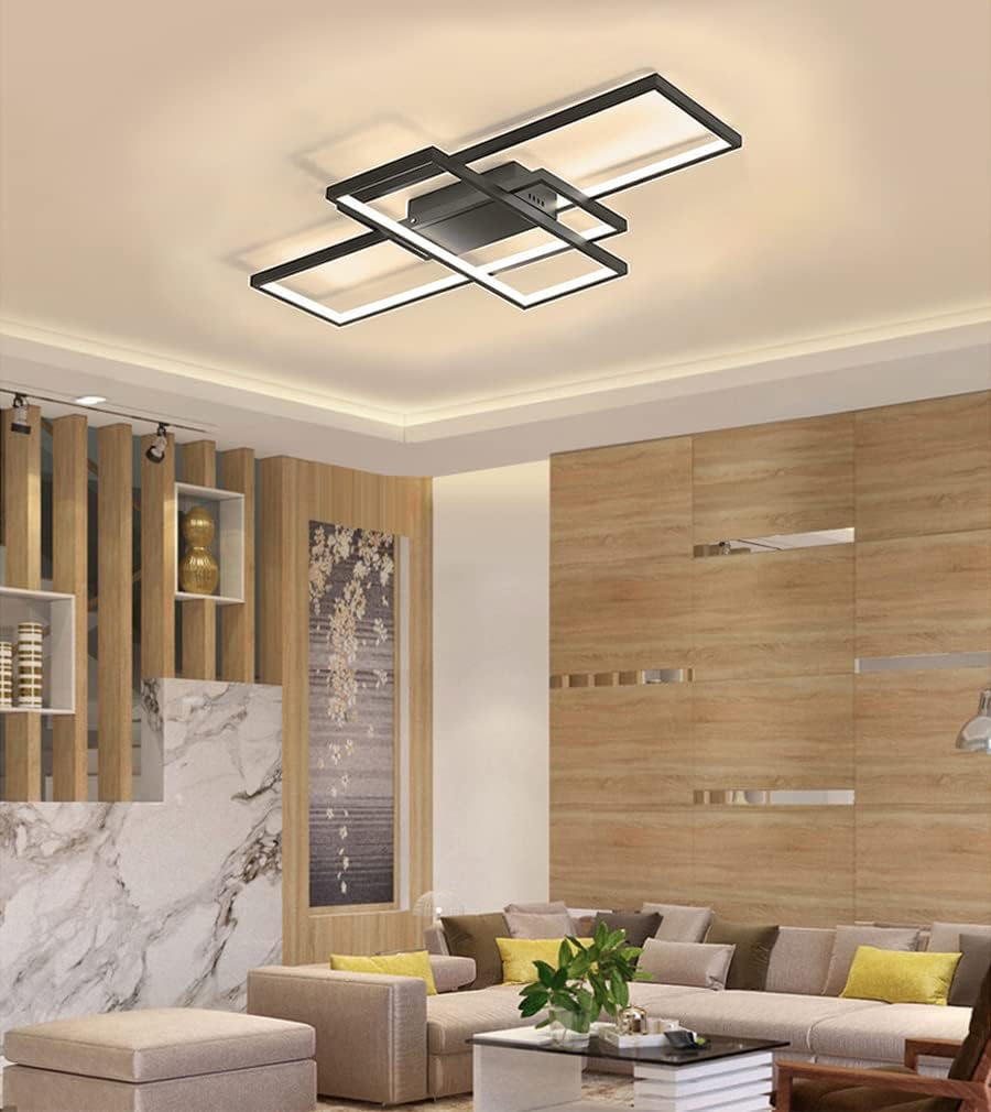 Modern living room with a ceiling light fixture, sofa, and decorative elements.