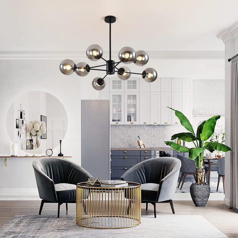 Modern living room with a chandelier, chairs, and a coffee table.