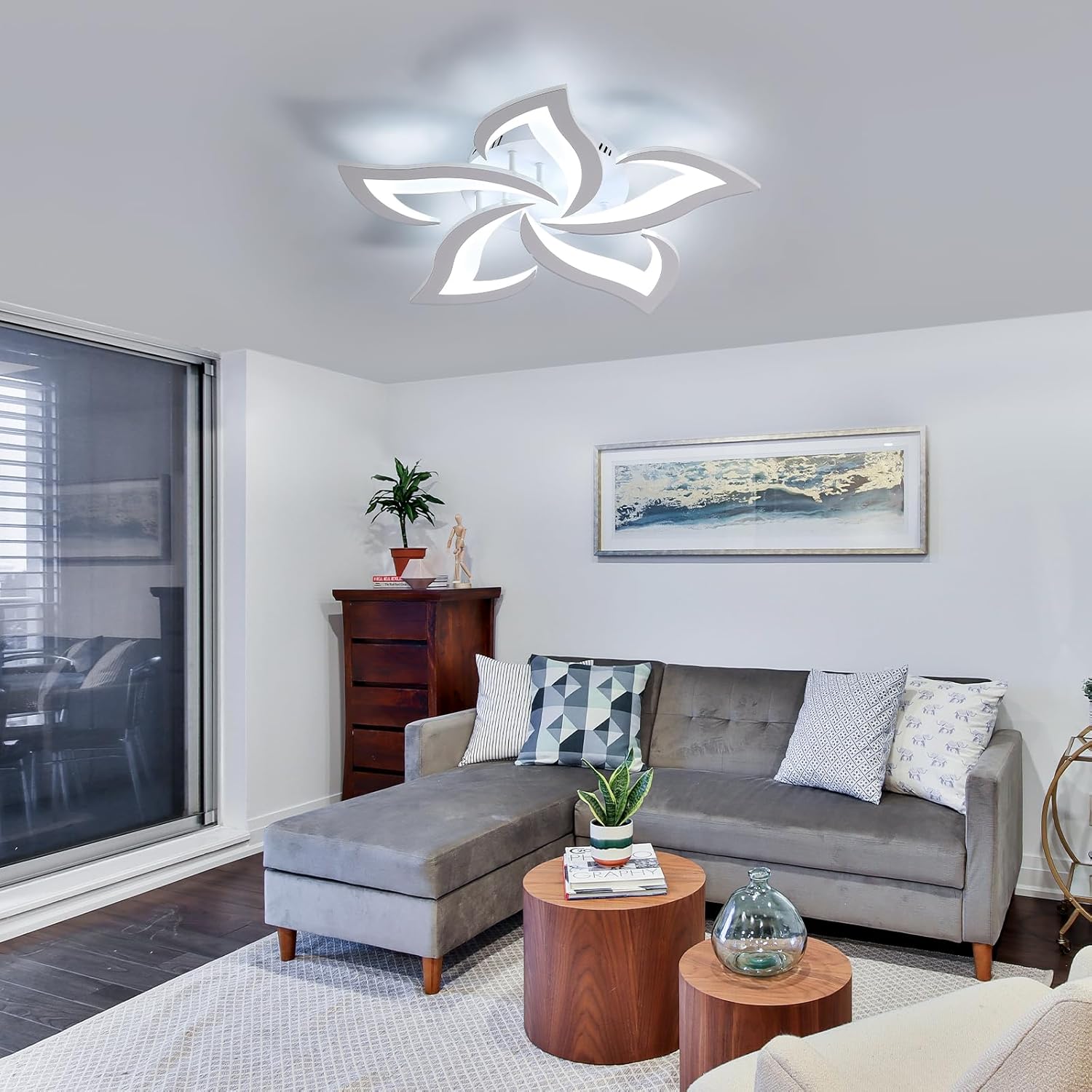 Modern living room with a gray sectional sofa, wooden coffee table, and decorative items.