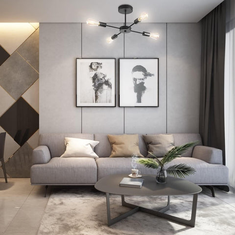 Modern living room with a gray sofa, coffee table, and decorative elements.