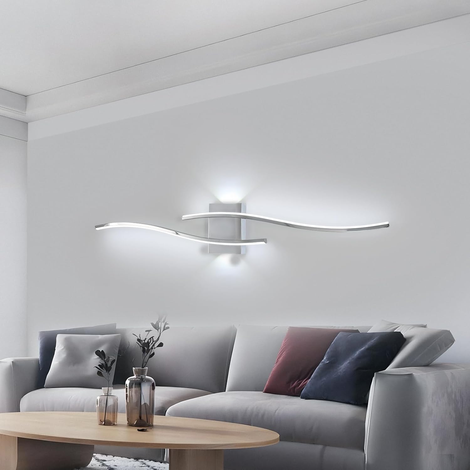 Modern living room with a gray sofa, wooden coffee table, and wall-mounted light fixture.
