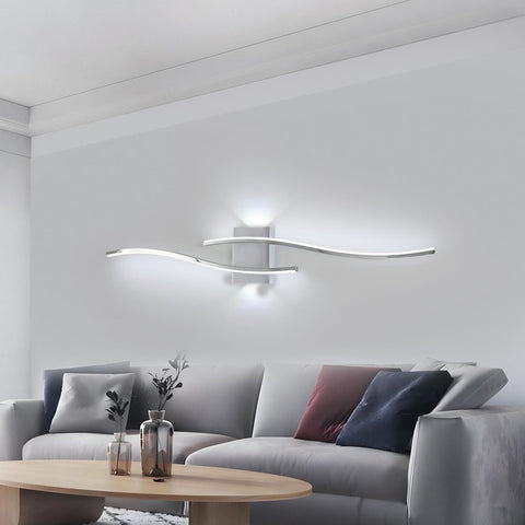 Modern living room with a gray sofa, wooden coffee table, and wall-mounted light fixture.