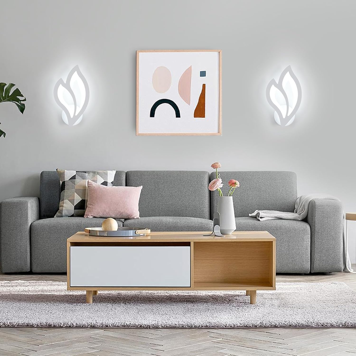 Modern living room with a gray sofa, wooden coffee table, and abstract art on the wall.