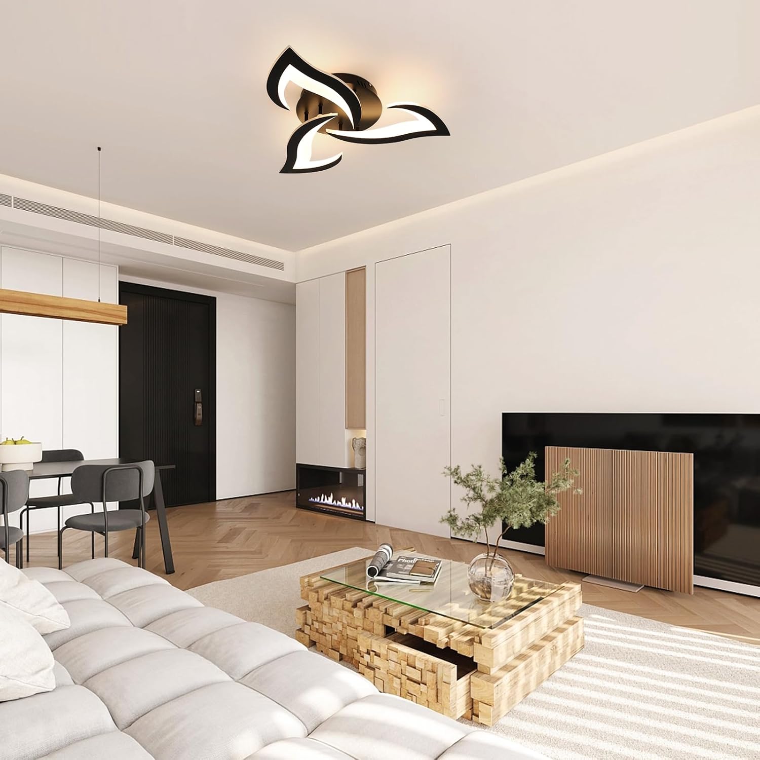 Modern living room with a stylish ceiling light fixture, sofa, coffee table, and fireplace.