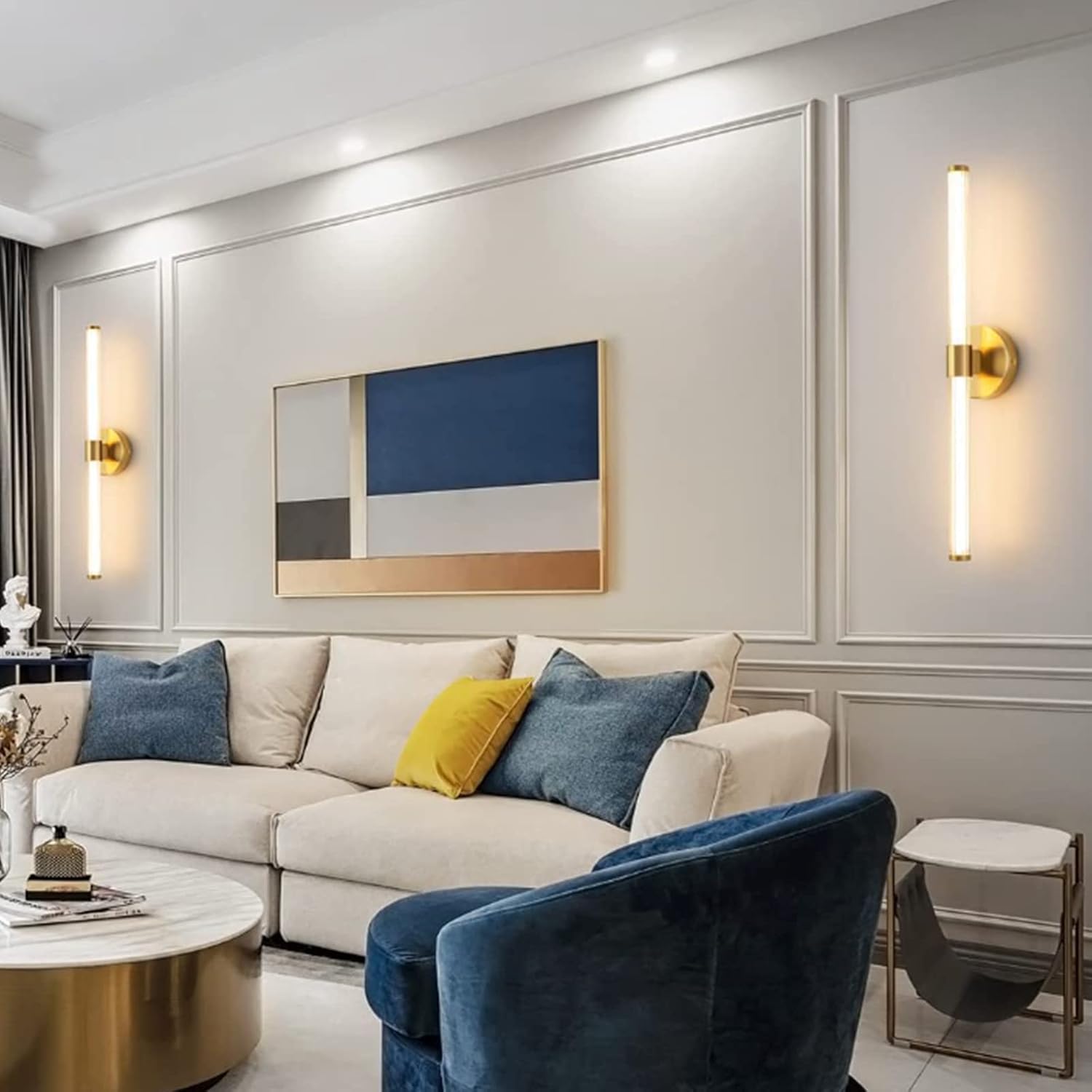 Modern living room with a white sofa, blue armchair, and abstract wall art.