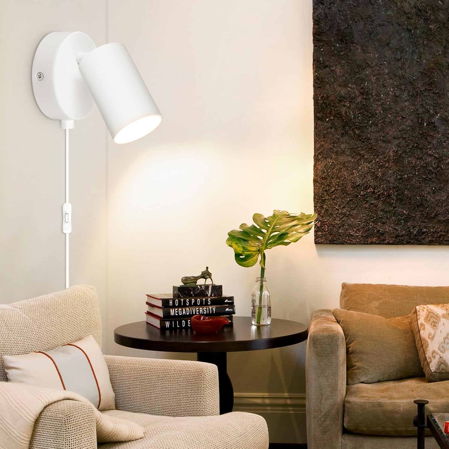Modern living room with beige armchair, sofa, and wall-mounted lamp.