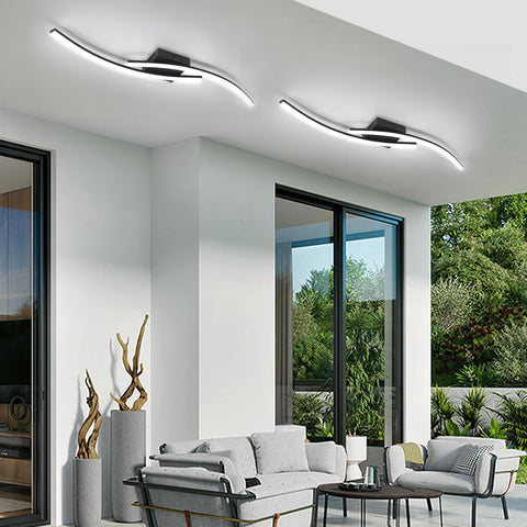 Modern living room with ceiling lights, sofa, and decorative elements.