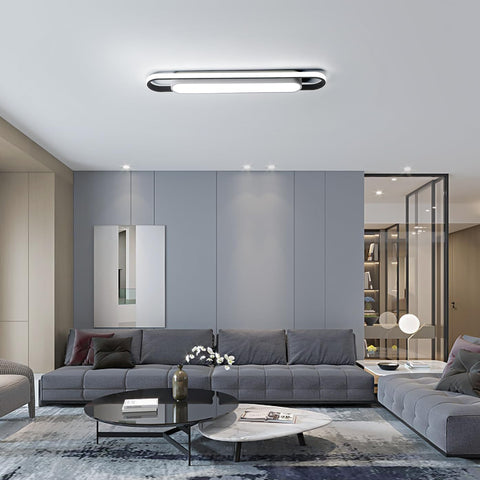 Modern living room with gray sectional sofa, coffee table, and decorative elements.