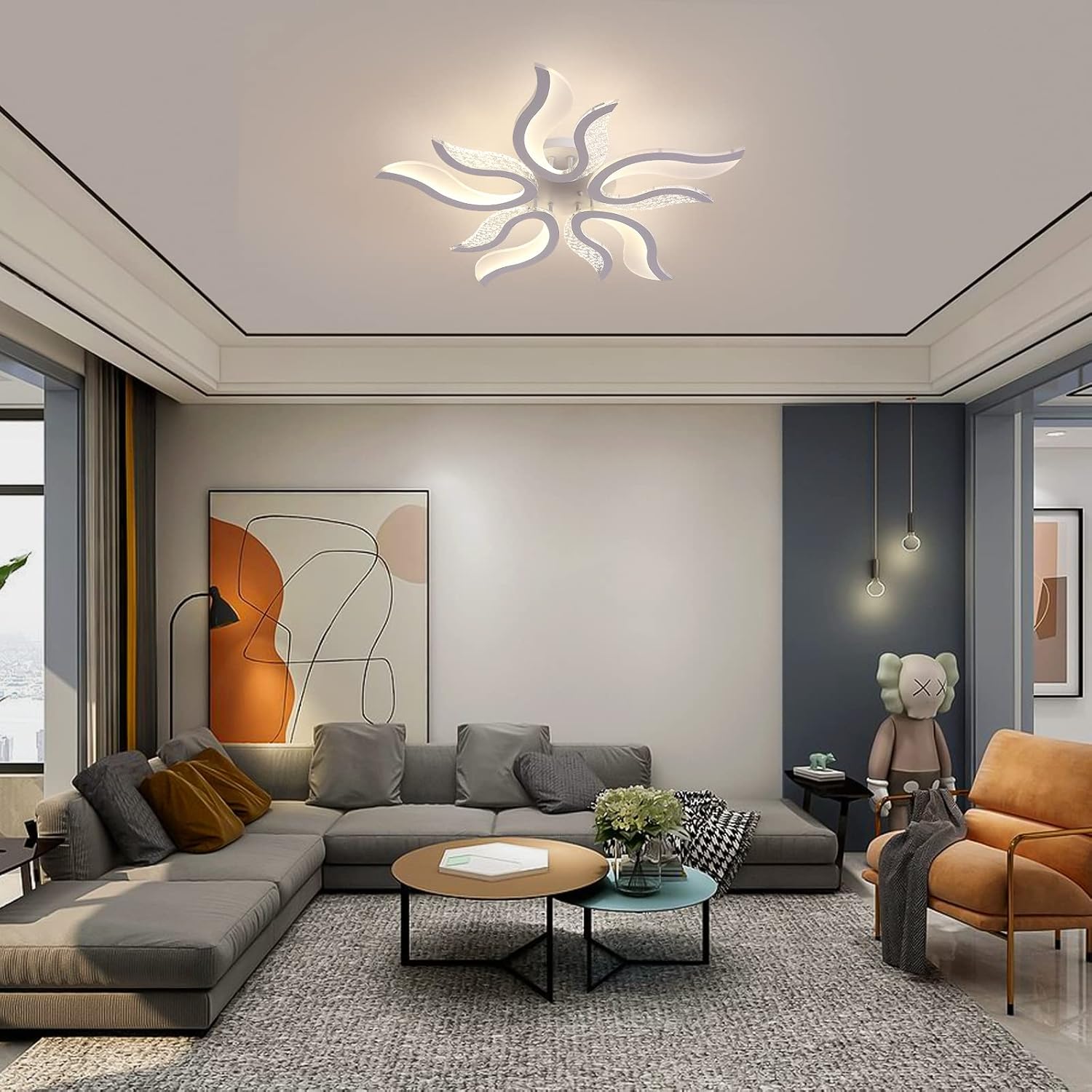Modern living room with gray sectional sofa, round coffee table, and abstract art on wall.