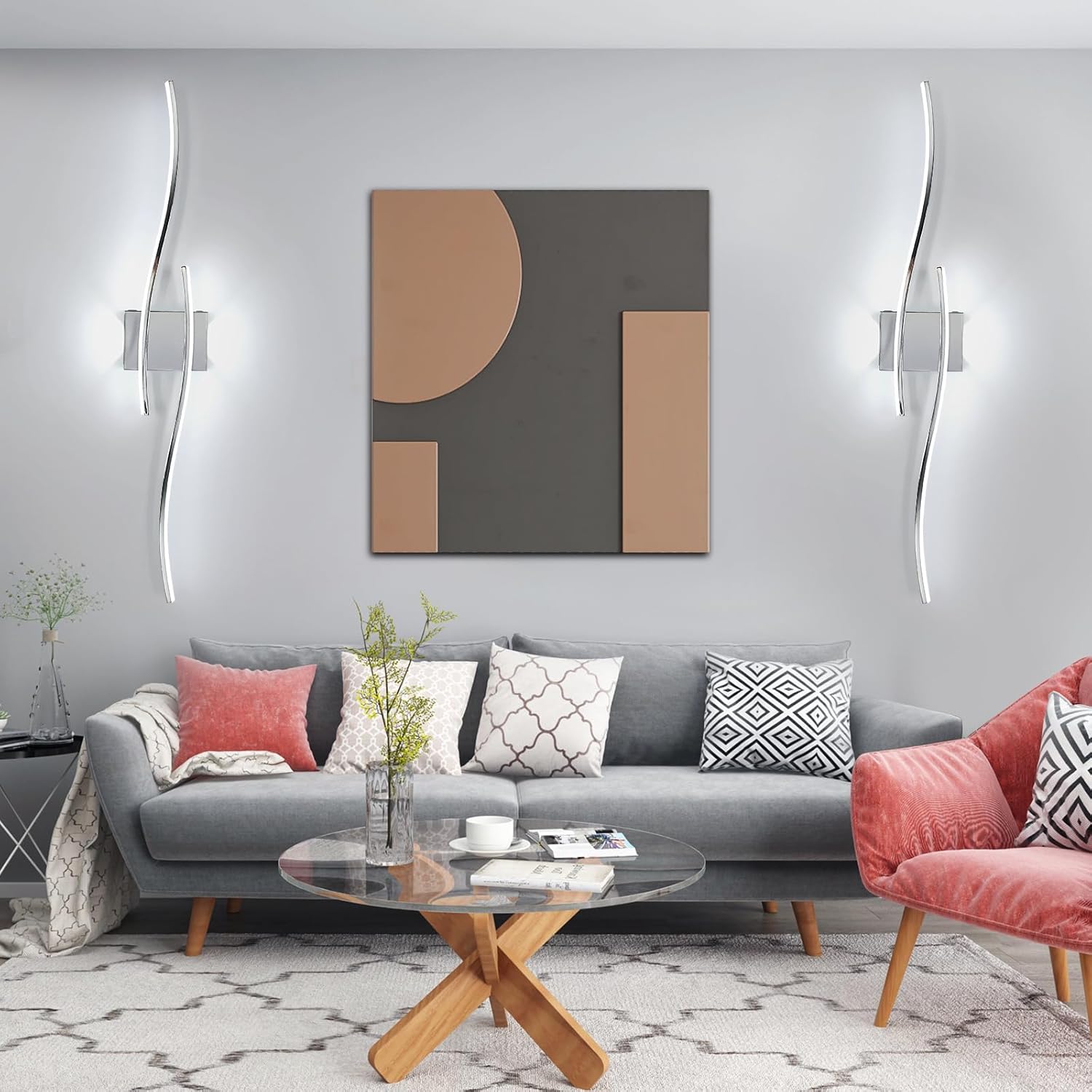 Modern living room with gray sofa, pink chair, and abstract wall art.