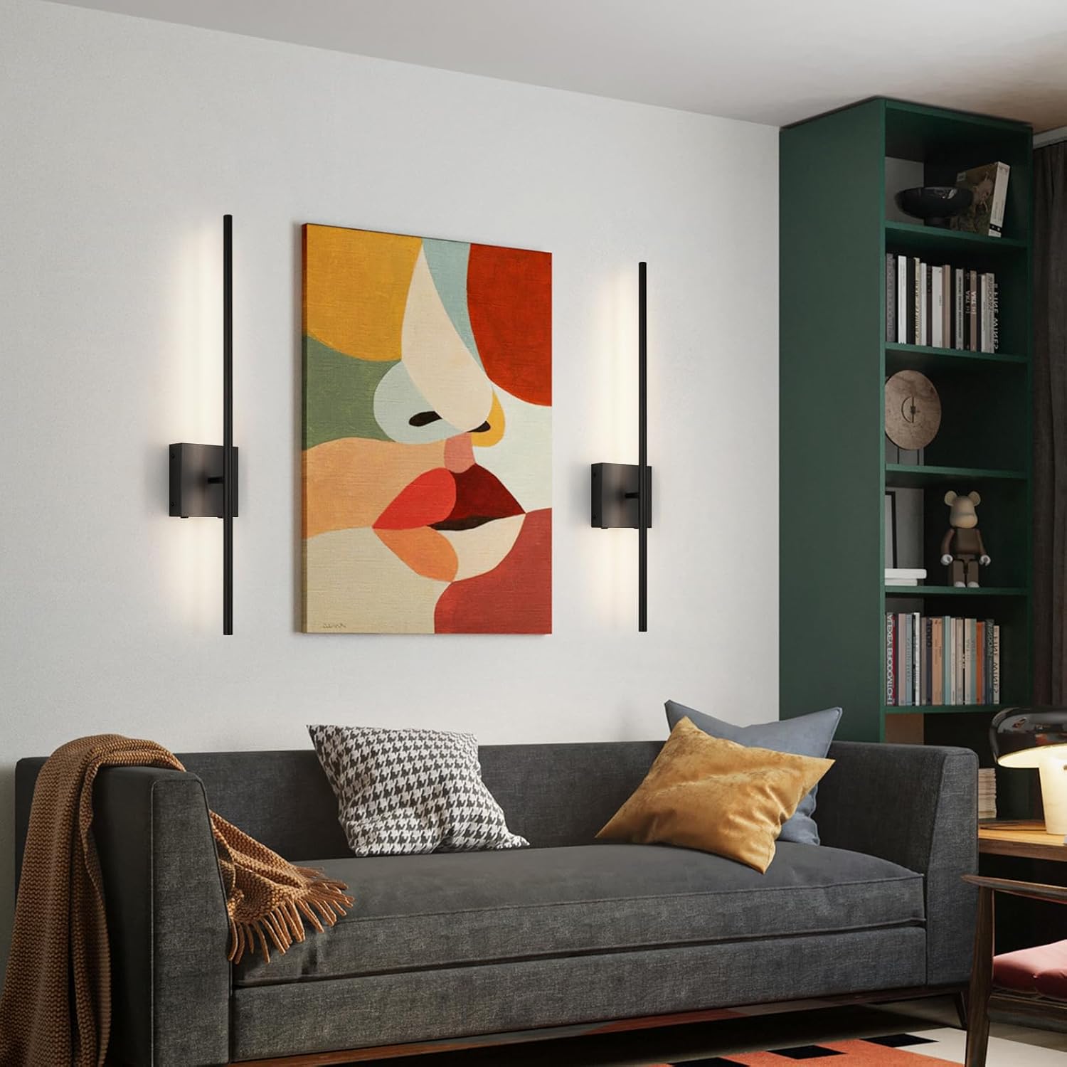 Modern living room with a gray sofa, colorful abstract painting, and bookshelf.