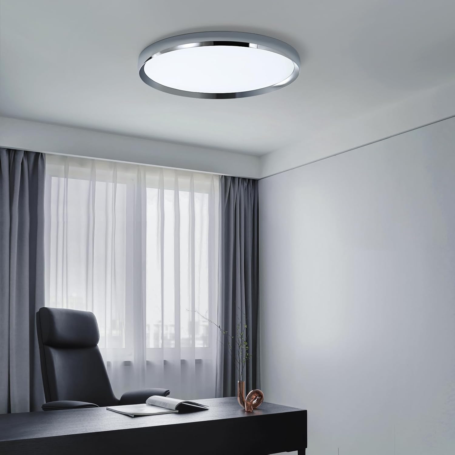 Modern office setup with a desk, chair, and ceiling light fixture.