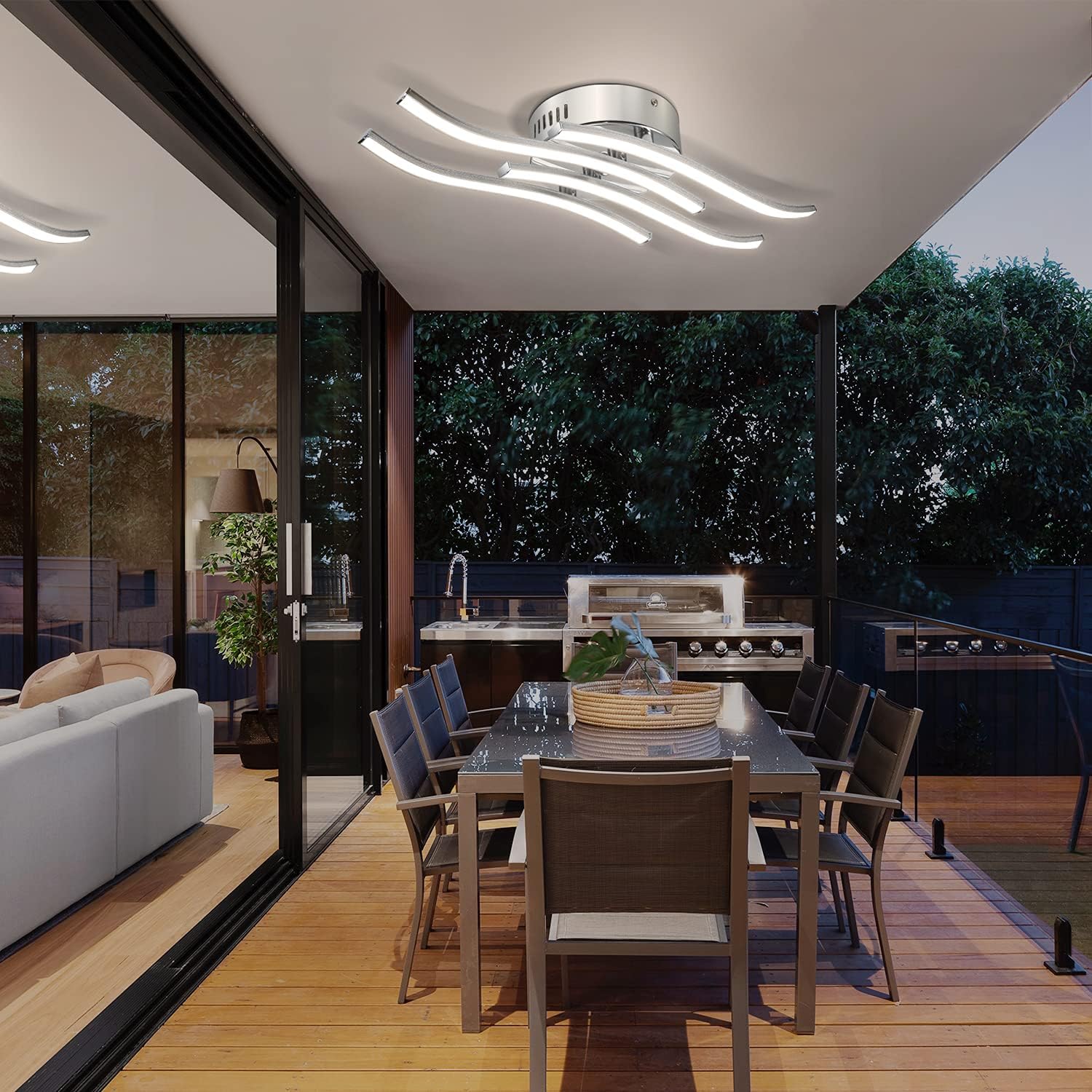 Modern outdoor kitchen with dining area at night