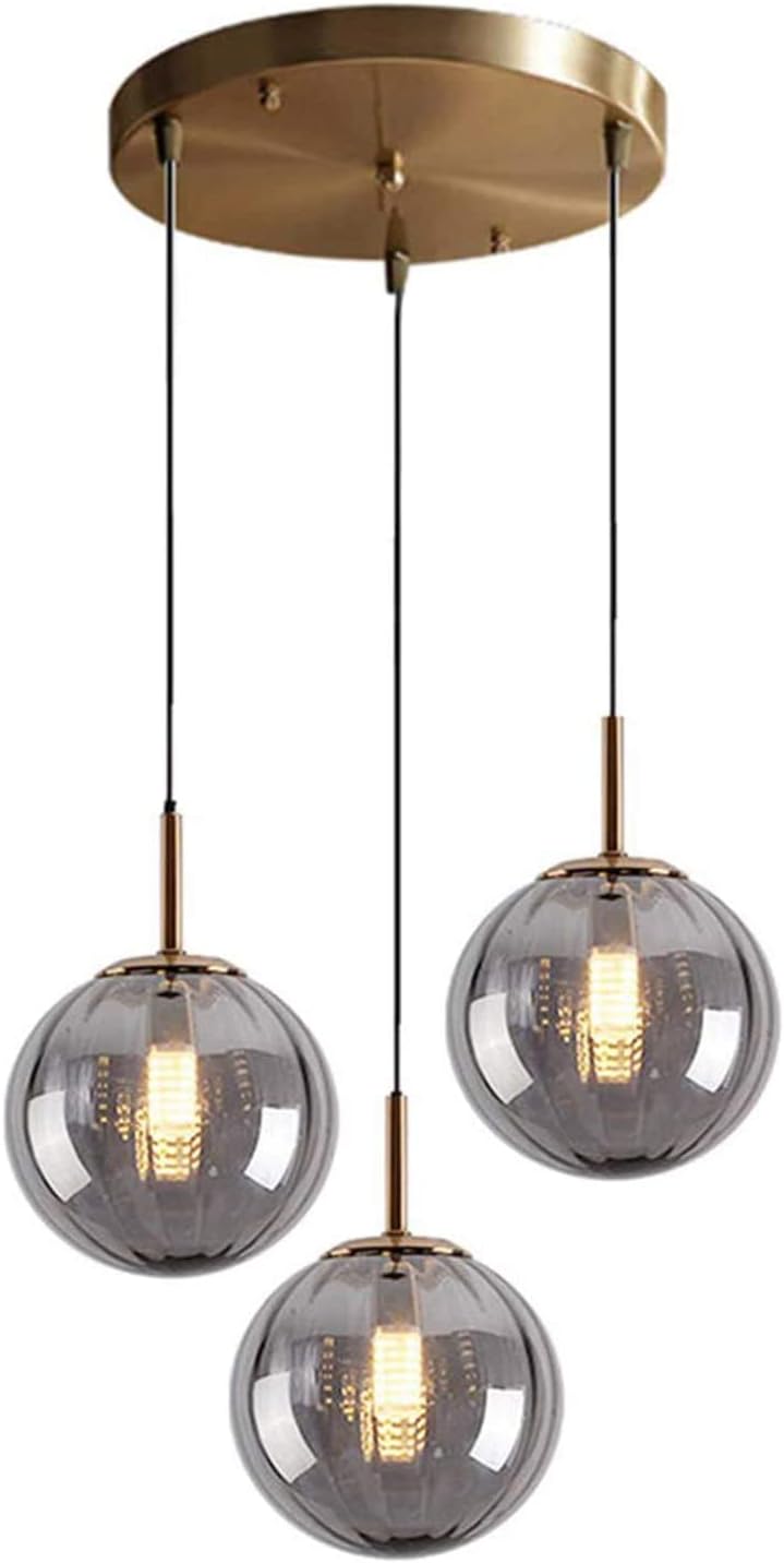 Modern pendant light fixture with three glass shades and gold accents on a white background